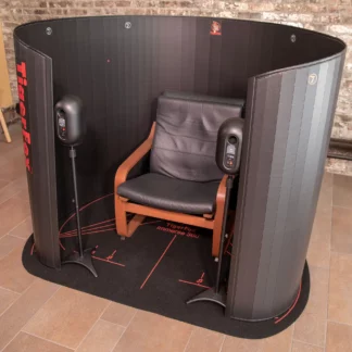 TigerFox Immerse 360 acoustic enclosure set up with speakers and chair.